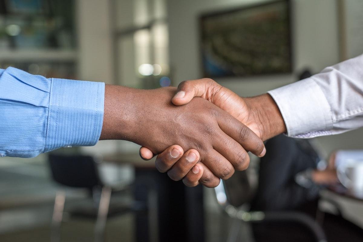 Small business owner hiring a bookkeeper — professional handshake